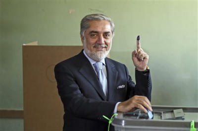 Afghanistan's presidential candidate Abdullah Abdullah poses for photos before he casts his vote at a pooling station in Kabul, Afghanistan, Saturday, June 14, 2014. Despite Taliban threats of violence, many Afghans vow to cast ballots in Saturdays presidential runoff vote with hopes that whoever replaces Hamid Karzai will be able to provide security and stability after international forces wind down their combat mission at the end of this year. (AP Photo/Massoud Hossaini)