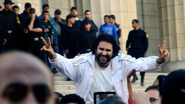 Prominent Egyptian activist Alaa Abdel-Fattah is surrounded by supporters after his release from detention in March. A court has convicted Abdel-Fattah for demonstrating without a permit and assaulting a policeman and sentenced him to 15 years in prison. (Mostafa Darwish / AP)