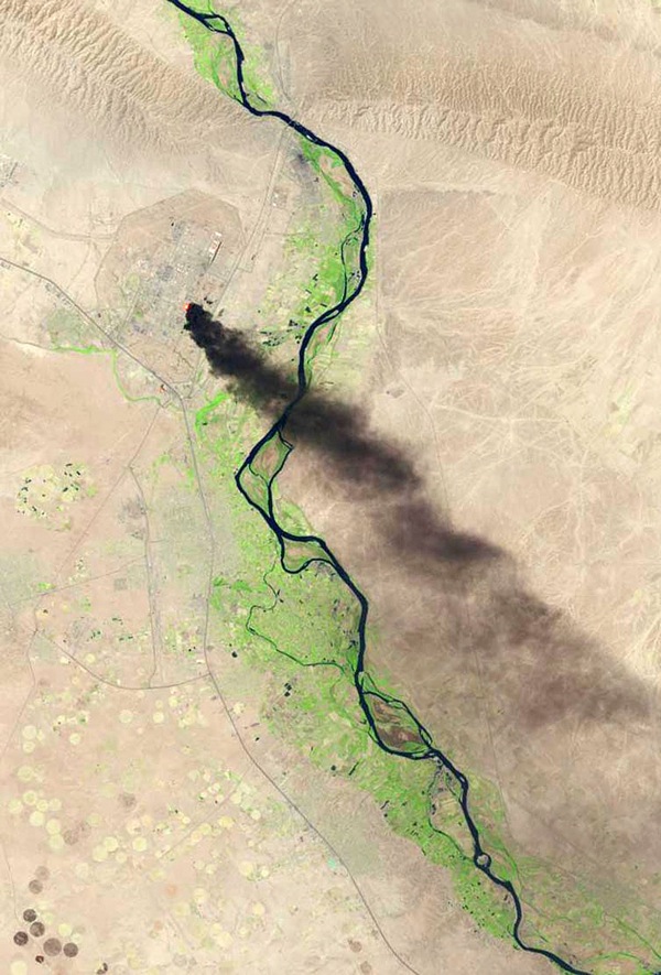 BAIJI, IRAQ - JUNE 18: In this handout photo provided by the USGS, A satellite view shows smoke billowing from the Baiji North refinery complex on June 18, 2014 in Baiji, about 130 miles north of Baghdad. An attack on the refinery started late on Tuesday night and continued into Wednesday morning as the Islamic State in Iraq and Syria (ISIS) militants move closer to Baghdad after taking control over several northern Iraqi cities. (Photo by USGS/NASA via Getty Images)