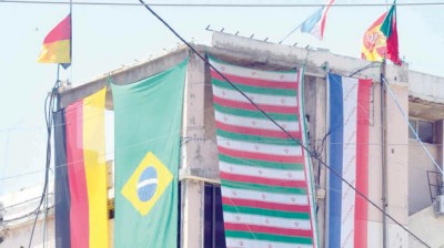 The Iranian flag competes for space with the flags of other FIFA World Cup 2014 contenders in southern Beirut. (Asharq Al-Awsat)