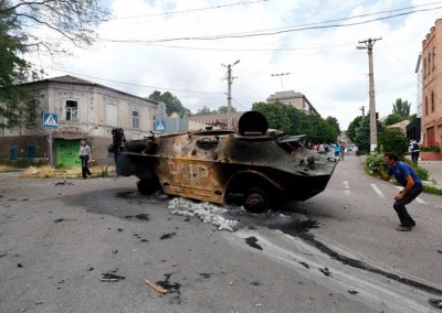 A destroyed armored personnel carrier in the port city of Mariupol, in eastern Ukraine, on Friday. Credit Shamil Zhumatov/Reuters