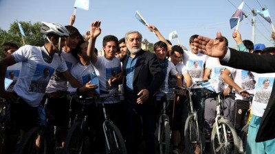 Afghan presidential candidate Abdullah Abdullah talks with supporters at a cycling event in Kabul shortly before two blasts struck his convoy. (Rahmat Gul / Associated Press)