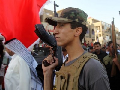 Iraqi tribesmen hold up their weapons as they gather to show their readiness to join Iraqi security forces in the fight against Jihadist militants who have taken over several northern Iraqi cities on June 16, 2014 in the capital Baghdad. Faced with a militant offensive sweeping south toward Baghdad, Prime Minister Nuri al-Maliki announced the Iraqi government would arm and equip civilians who volunteer to fight, and thousands have signed up. AFP PHOTO/AHMAD AL-RUBAYE (Photo credit should read AHMAD AL-RUBAYE/AFP/Getty Images)