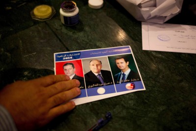 A man votes for President Bashar al-Assad, marking his ballot with blood. The vote in Syria is expected to hand Mr. Assad another seven-year term