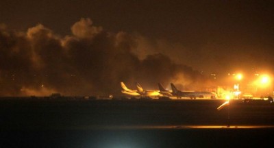 Fire illuminates the sky above the Jinnah International Airport in Karachi where security forces are fighting with attackers Sunday night, June 8, 2014, in Pakistan. Gunmen disguised as police guards attacked a terminal with machine guns and a rocket launcher during a five-hour siege that killed 13 people as explosions echoed into the night, while security forces retaliated and killed all the attackers, officials said Monday. Photo: Fareed Khan, AP