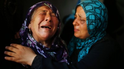 Palestinian women mourn during the funeral of their relatives in Gaza