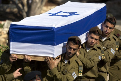 Israeli soldiers carry the coffin of Staff Sgt. Moshe Melako, 20, during his funeral at the Mount Herzel military cemetery in Jerusalem, Monday, July 21, 2014. Melako was one of 13 soldiers killed in several separate incidents in Shijaiyah on Sunday, as Israel-Hamas fighting exacted a steep price, killing scores of Palestinians and more than a dozen Israeli soldiers. In Israel, a country where military service is mandatory for most citizens, military losses are considered every bit as tragic as civilian ones. (AP Photo/Sebastian 