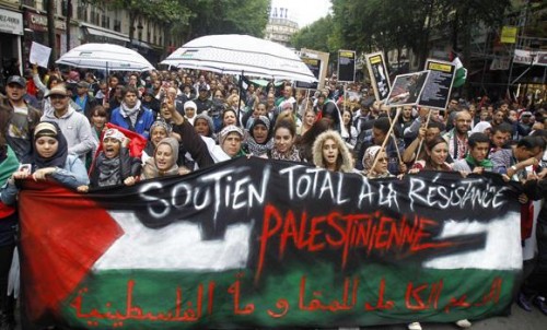 Thousands of pro-Palestinian demonstrators holding banners and chanting anti Israeli slogans walk in Paris on Sunday to protest against the Israeli army's bombings in the Gaza strip. (AP Photo/Remy de la Mauviniere)