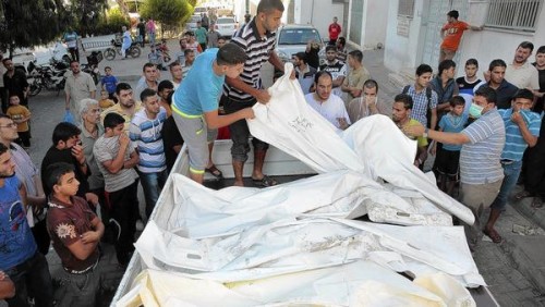 The bodies of 11 members of the Hilo family, who died in the bombing of their Shajaiya home, are taken for burial in Gaza City. (Carolyn Cole / Los Angeles Times)