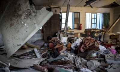 A Palestinian scout collects human remains from a classroom inside a UN school in Gaza City after the area was hit by shelling on July 30, 2014. Israeli bombardments early on July 30 killed "dozens" of Palestinians in Gaza, including at least 16 at a UN school, medics said, on day 23 of the Israel-Hamas conflict.    AFP PHOTO / MARCO LONGARIMARCO LONGARI/AFP/Getty Images