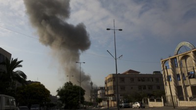 Smoke comes from building in Gaza hit by Israeli shelling