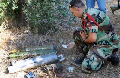 A Lebanese army expert dismantles two rockets that were found ready to fire into northern Israel, in the southern Lebanese village of Al-Mari, Lebanon, Friday, July. 11, 2014. The Lebanese army said in a statement that an "unknown side" fired three rockets Friday morning from the Marjayoun-Hasbaya region toward Israel. (Lotfallah Daher, AP / AP)