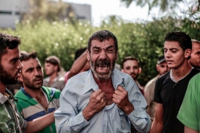 Father's Grief: The father of one of the four boys, all from the Baker family, killed during Israeli shelling, react outside the al-Shifa hospital in Gaza City.