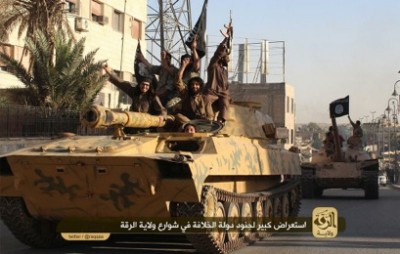 An image made available by Jihadist media outlet Welayat Raqa on Jun 30, 2014, allegedly shows a member of the IS (Islamic state) militant group parading with a tank in a street in the northern rebel-held Syrian city of Raqa.