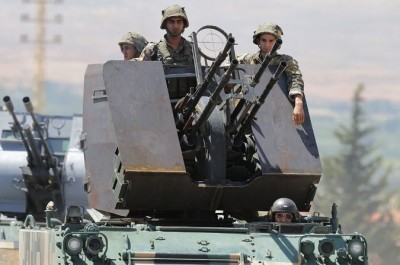 Lebanese soldiers on Monday driving into Arsal, where battles with Islamists continued and thousands of residents had fled. Credit Joseph Eid/Agence France-Presse — Getty Images