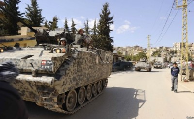 Lebanese army soldiers patrol the border town of Arsal in an armored vehicle.