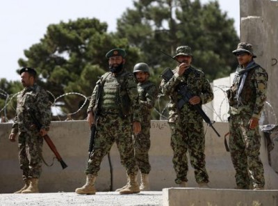  Afghan National Army (ANA) soldiers keep watch at the gate of a British-run military training academy Camp Qargha, in Kabul August 5, 2014.  CREDIT: REUTERS/OMAR SOBHANI