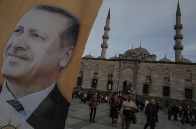 A poster of Turkish Prime Minister Recep Tayyip Erdogan is seen in an election billboard of his Justice and Development Party with a mosque in the background in Istanbul, Turkey