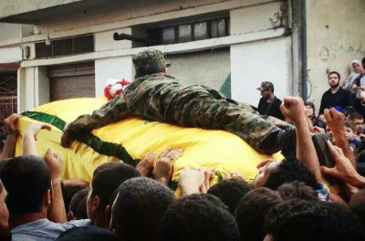 Ibrahim al-Haj's son clings to his father's coffin. Haj was killed in a battle near Mosul, sources say [Al Jazeera]