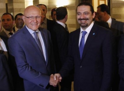 Lebanon's Prime Minister Tammam Salam (L) shakes hands with former Lebanese prime minister Saad al-Hariri 