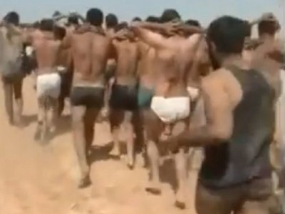 An image from a video uploaded on social networks Thursday shows men in being marched along a desert road before being allegedly executed by Islamic State militants in Syria's Raqa Province.