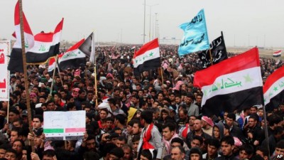 Sunni protesters chant slogans against the Iraq's Shiite-led government as they wave national flags during a 2013 demonstration in Fallujah