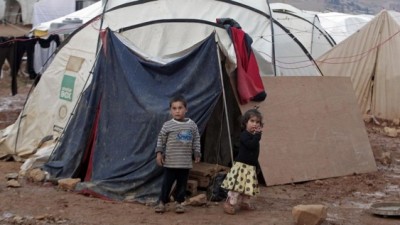 Syrian children stand near their tent at a refugee camp in the eastern Lebanese border town of Arsal, Lebanon, on Monday, November 18, 2013. (photo credit: AP Photo/Bilal Hussein)