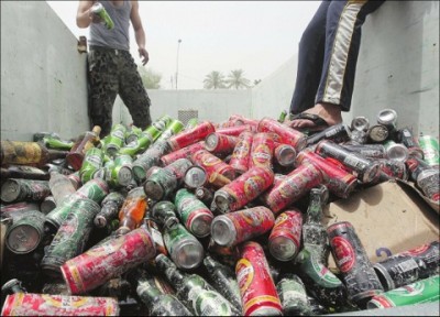 An Iraqi throws beer cans in a pile from a liquor store that was targeted in a car bomb attack that destroyed 11 liquor stores in Baghdad in 2011. While Islam prohibits alcohol, Baghdad has had a flourishing drinking scene in the past. Photograph by: Ahmad Al-Rubaye, Getty Images , Bloomberg