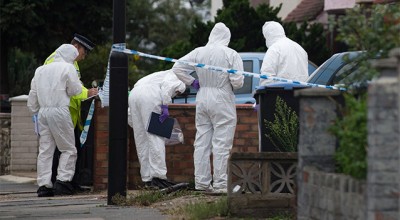Forensic investigators examine a property in Edmonton where a woman is thought to have been beheaded. Photo: Getty Images