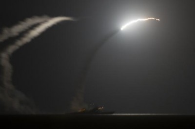 The guided-missile cruiser USS Philippine Sea launches a Tomahawk cruise missile, as seen from the aircraft carrier USS George H.W. Bush, in the Arabian Gulf, September 23, 2014.  REUTERS/Mass Communication Specialist 1st Class Eric Garst/U.S. Navy