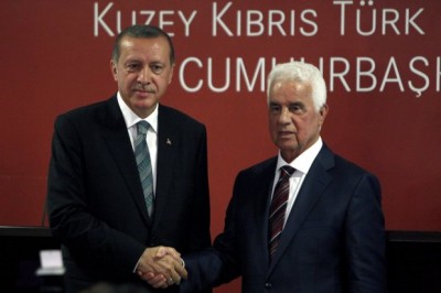 Turkey's new President Recep Tayyip Erdogan, left, and Turkish Cypriot leader Dervis Eroglu shake hands after a press conference and their meeting in the breakaway Turkish Cypriot north of ethnically divided Cyprus on Monday, Sept. 1, 2014. This is Erdogan's first visit abroad since his election last month. Cyprus was divided in 1974 when Turkey invaded after a coup by supporters of union with Greece. (AP Photo/Petros Karadjias)