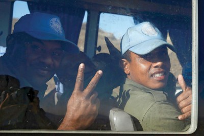 Two of the Fijian UN peacekeepers released by Al Qaeda-linked group Nusra Front in Syria, gesture from inside a vehicle as they arrive in Israeli occupied   Golan Heights