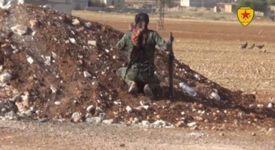  Kurdish soldier prepares to fire his RPG at an Isis tank in Kobane, Syria (Youtube/YPG in Syria)