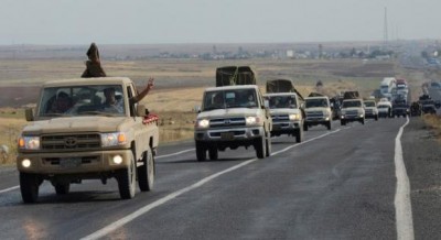 A convoy of Kurdish Iraqi peshmerga vehicles makes its way to the Turkish-Syrian border, near the town of Kiziltepe, in the southeastern Mardin province October 29, 2014. REUTERS/Stringer