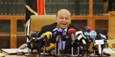 Yemen's President Abd-Rabbu Mansour Hadi speaks as he holds an agreement (L) signed between the government and Houthi rebels, in Sanaa September 21, 2014. REUTERS/Mohamed al-Sayaghi
