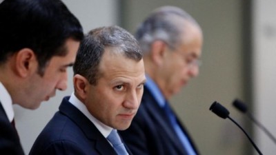 Minister of Foreign Affairs of Lebanon, Gebran Bassil, center, listens to the translator as his Cyprus counterpart Ioannis Kasoulides speaks during a press conference at the foreign ministry house in Capital Nicosia, Wednesday, Nov. 26, 2014. Bassil is in Cyprus for an official visit. (AP Photo/Petros Karadjias) (The Associated Press) Next 