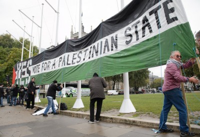 Pro-Palestinian supporters position a giant banner calling for a recognised Palestinian State, in Parliament Square, central London on Oct. 13, 2014.