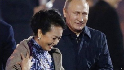 Putin stole the limelight on Monday when at an Apec party he carefully placed a shawl over the shoulders of China's stylish first lady Peng Liyuan.  Ms Peng accepted the offer, but removed the shawl only seconds later