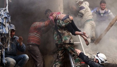 Men rescue a boy from under the rubble of a building damaged by what activists said where explosive barrels dropped by forces loyal to Syria's President Bashar Al-Assad in the Al-Shaar neighbourhood of Aleppo (4/6). REUTERS/Hosam Katan