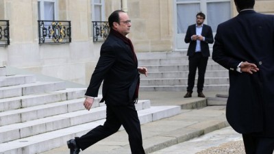 French President Francois Hollande leaves the Elysee Palace after a shooting at a French satirical newspaper, in Paris, France, Wednesday, Jan. 7, 2015.