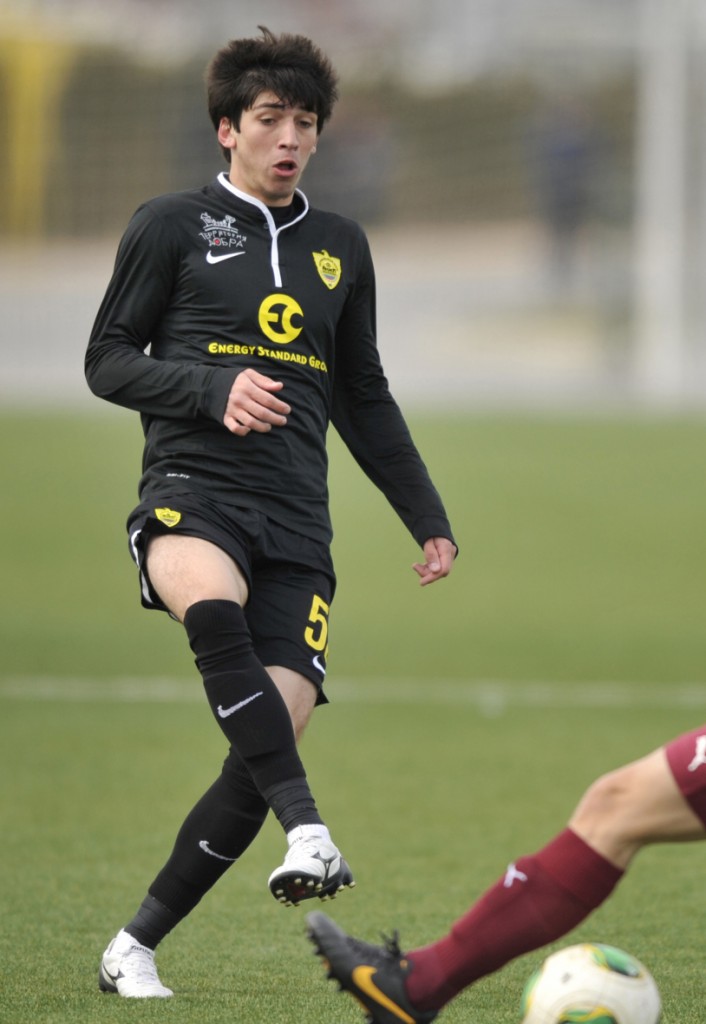 In this photo taken on Saturday, March  8, 2014, Gasan Magomedov,  20-year-old soccer player for Russian club Anzhi Makhachkala runs with the ball in Makhachkala, Russia. Magomedov has been shot dead near his home in Russia's volatile North Caucasus. Gasan Magomedov was driving into his home village late on Saturday, Jan. 3, 2015 when his car was sprayed with machine-gun fire and he died from his wounds while being transported to hospital, Anzhi said in a statement. No arrests have been made and the motive is unclear, the club said. There were no reports of any other casualties. (AP Photo/Sergei Rasulov jr.)