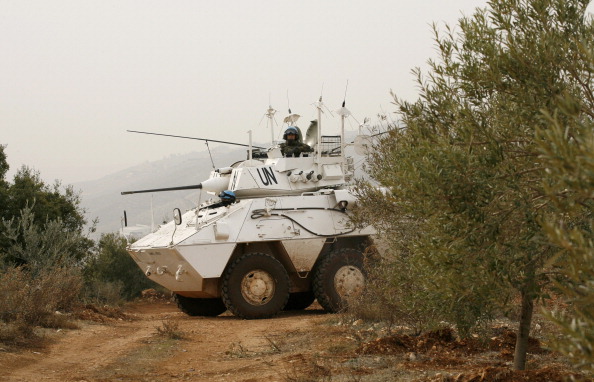 A United Nations UNIFIL soldier from the Spanish contingent, sits in an armored vehicle after 20 shells were fired by the Israeli army into southern Lebanon, near Rashaya al-Fukhar on December 29, 2013,