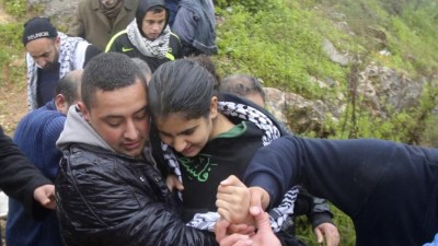 Palestinian schoolgirl Malak al-Khatib (C), 14, is carried by a relative after her release from an Israeli jail at a checkpoint near the West Bank city of Tulkarm February 13, 2015. Israeli authorities released Khatib on Friday after a 45-day detention in prison following her arrest. The Israeli army had arrested Khatib, a student in the eighth grade, as she was returning from school in her village near Ramallah, and had charged her with throwing stones and possession of a knife. REUTERS