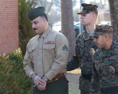 Cpl. Wassef Hassoun, left, is escorted to the courtroom on Camp Lejeune in Jacksonville, N.C., Monday, Feb. 9, 2015, for the beginning of his court martial trial. The U.S. Marine who vanished from his post in Iraq a decade ago and later wound up in Lebanon chose Monday to have his case decided by a military judge instead of a jury. Hassoun's military defense attorney Capt. Brittaney Bennett walks with him. (AP Photo/The Daily News, John Althouse)