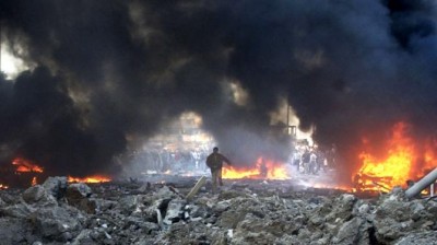 In this Feb. 14, 2005, file photo, vehicles burn following a massive bomb attack that tore through the motorcade of former Prime Minister Rafik Hariri in Beirut, Lebanon. The explosion killed Hariri 10 years ago sent a tremor across the region and unleashed a uprising that briefly united the Lebanese and ejected Syrian troops from the country.