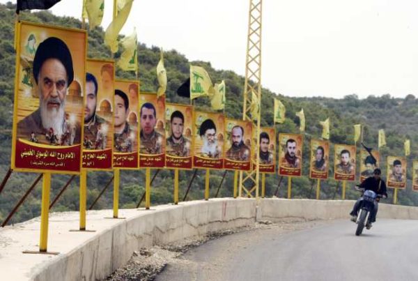 A poster of Iran's late spiritual leader Ayatollah Ruhollah Khomeini (L) and current supreme leader Ali Khameni (6th L) are included in a row of posters of Hezbollah martyrs lining a street in the southern Lebanese village of Yaater, southeast of Tyre on April 10, 2008. The portraits of politicians and killed combatants fill the streets of Lebanon, a symbol of the fact that the worship of the martyr remains alive. AFP PHOTO/RAMZI HAIDAR (Photo credit should read RAMZI HAIDAR/AFP/Getty Images)