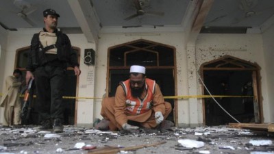 A rescue worker collects evidence from the site of an explosion in a Shi'ite mosque in Peshawar February 13, 2015. At least 19 people were killed on Friday in the Pakistani city of Peshawar in a gun and bomb attack on the Shi'ite mosque, the latest sectarian violence to hit the South Asian nation. (REUTERS)