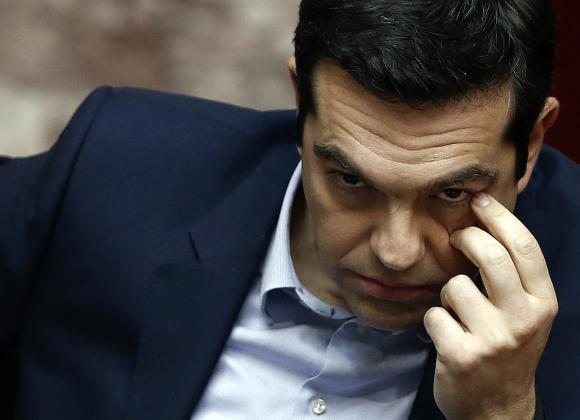 Greek Prime Minister Alexis Tsipras looks on before addressing lawmakers during a parliamentary session for the creation of a committee for claiming World War II war reparations at the parliament building in Athens March 10, 2015.  REUTERS/Alkis Konstantinidis