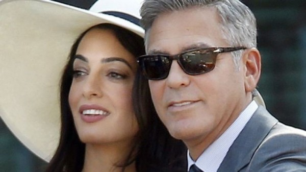 Actor and activist George Clooney with his wife Amal Ramzi Alamuddin Clooney , a London-based Lebanese-British lawyer, activist, and author