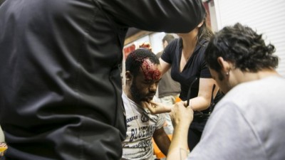 An Israeli Jew of Ethiopian origin is treated for an injury incurred during a demonstration in Tel Aviv on Sunday. Photo: Reuters